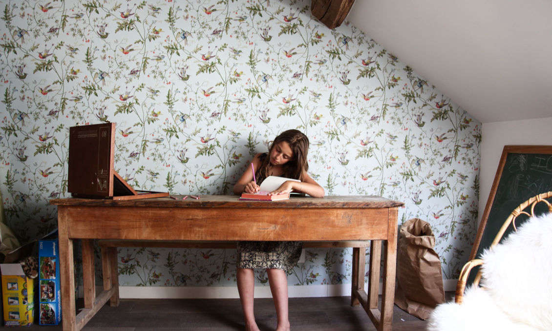 The bedrooms in the house are cozily tucked under the rafters in what had been the hayloft.