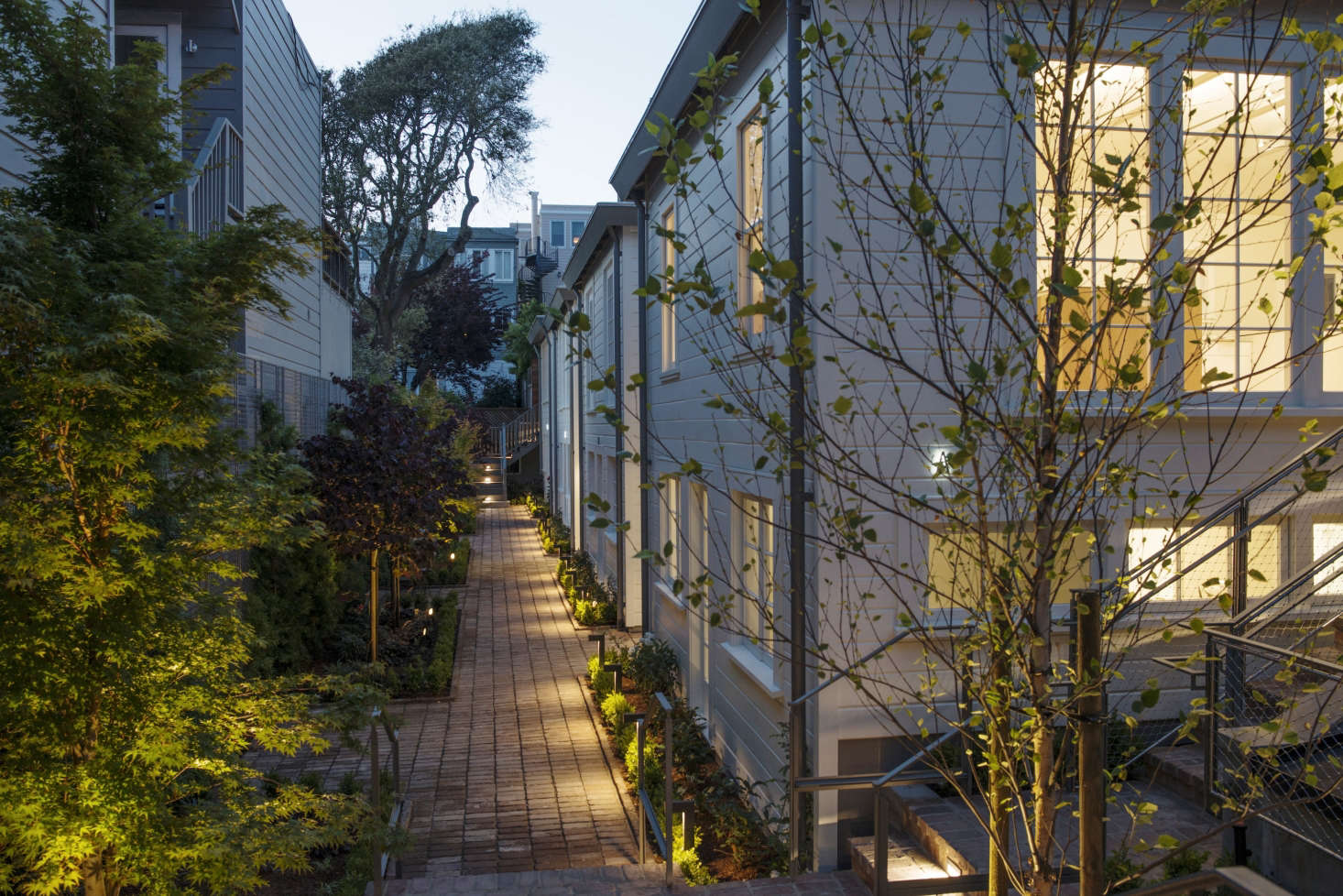 Though not visible here, parts of the exterior have zinc rainscreen siding—which creates an air gap between the screen and the building to allow for drainage and evaporation of moisture—as well as zinc downspouts running the height of each cottage.