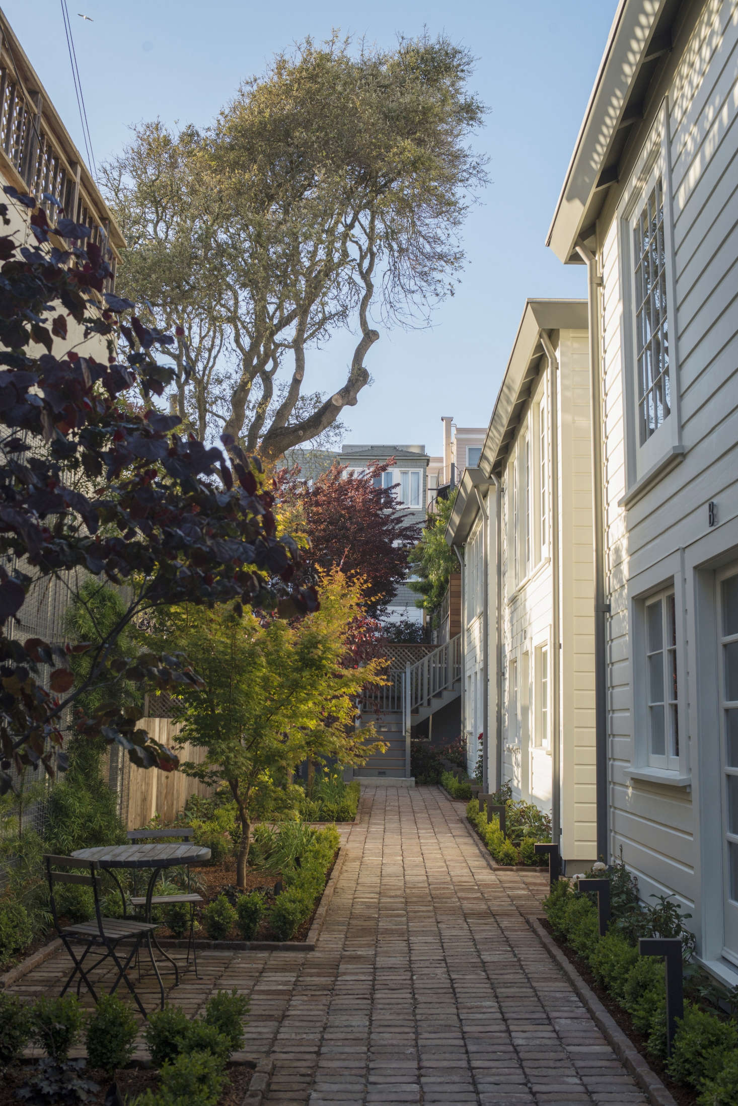 The exterior siding is reclaimed redwood shiplap from the original cottages, paired with new cedar siding cut to match and painted in Benjamin Moore