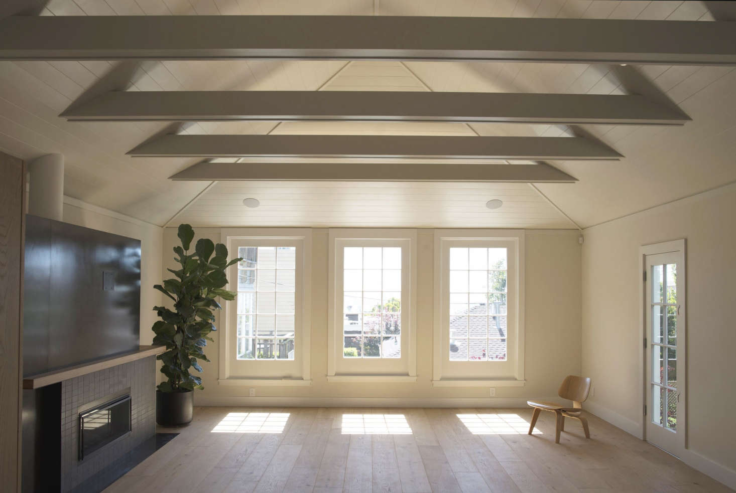 The windows and doors in the main areas are single glazed, reused from the original cottages. The interior walls are painted in Benjamin Moore