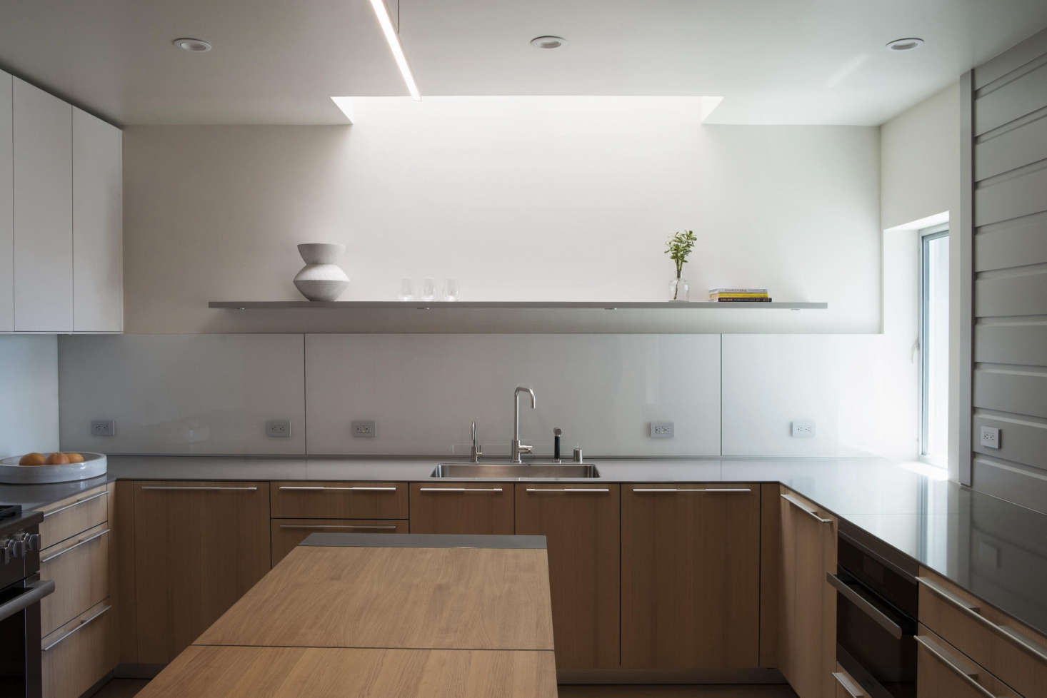 The kitchens are by Bulthaup, with Miele appliances and quartzite countertops.