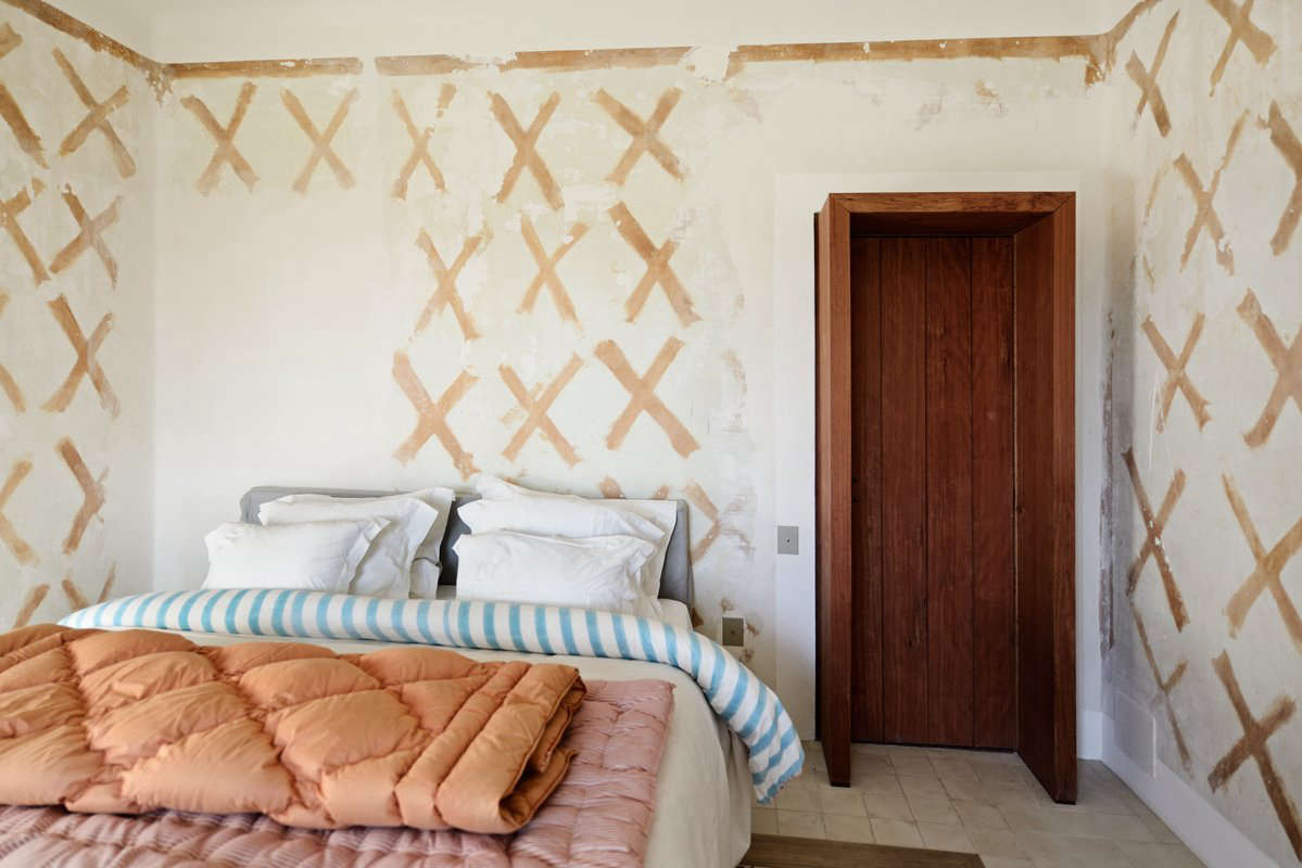 Adding improvisation to the design process, architects and designers are exposing beams, rough plaster walls, and whatever else is found beneath superficial surfaces. Designer Deborah Ehrlich explains the appeal; she likes the “archeological history of it.” Here, old wallpaper glue makes an X-shape pattern in a Provence house by LSL Architects.