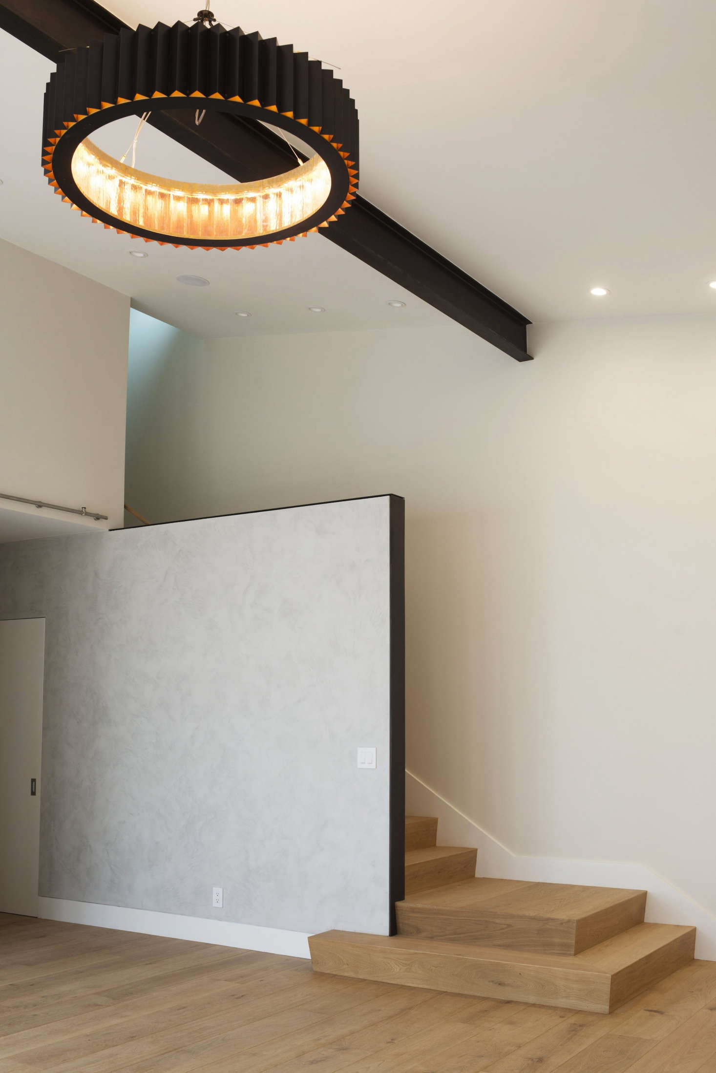 In the living room of the same cottage: a gray Venetian plaster detail wall by Level 5 Design in Berkeley.