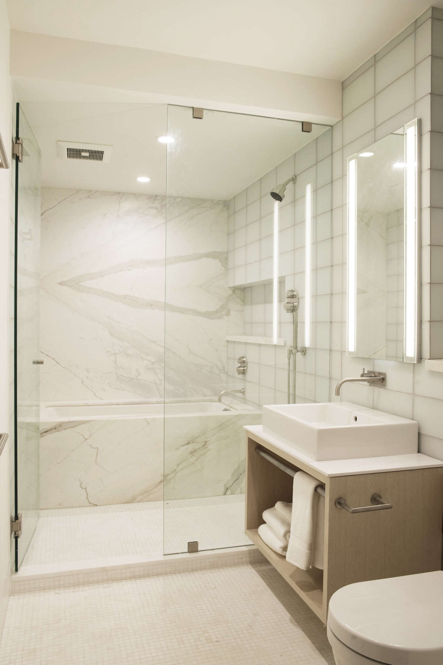 A ground-floor bathroom has a Calacatta d
