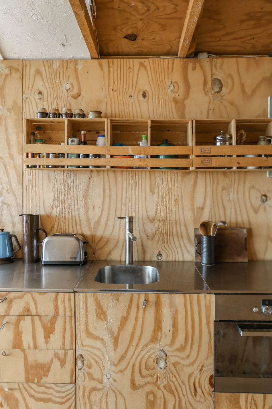 A lineup of garlic boxes salvaged from a local grocery serve as over-the-counter storage—