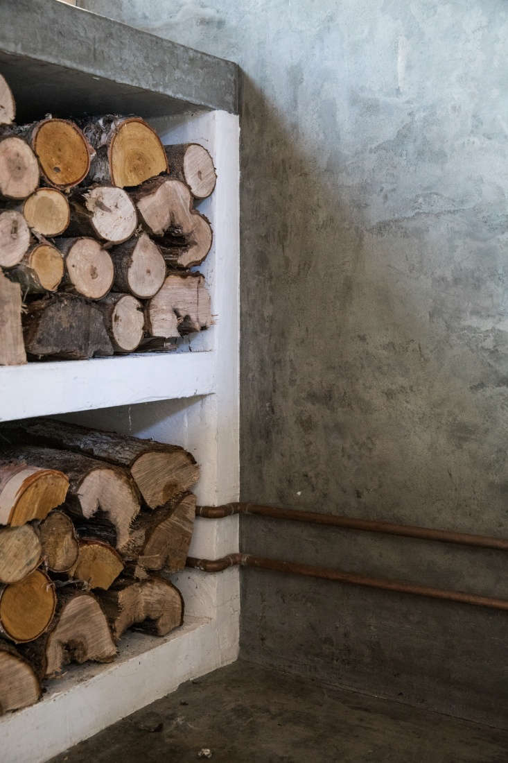 Soot House Stacked Wood in Kitchen by Anthony Esteves on Spruce Head in Maine, Photo by Greta Rybus