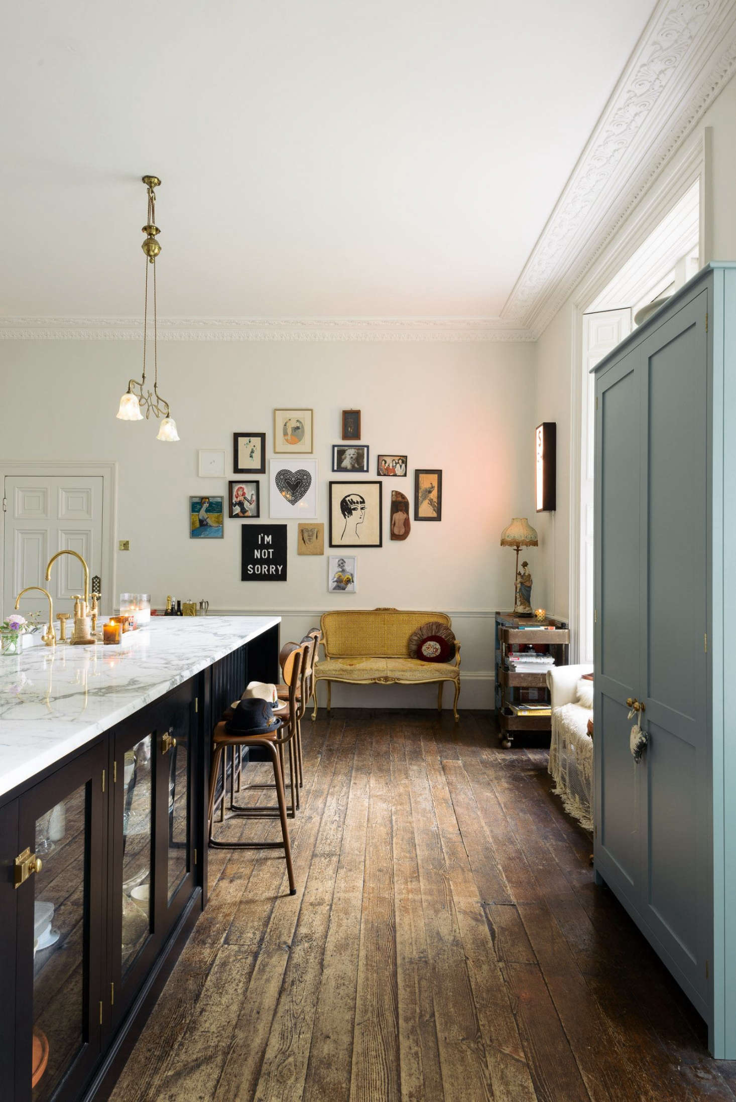 The faucet is a Brass Ionian Tap and Rinser by deVOL for Perrin & Rowe, paired with a hot water faucet. The art wall at the back of the kitchen mixes flea market finds with pieces by Zoe Grace, a contemporary artist and friend of Lowe’s.