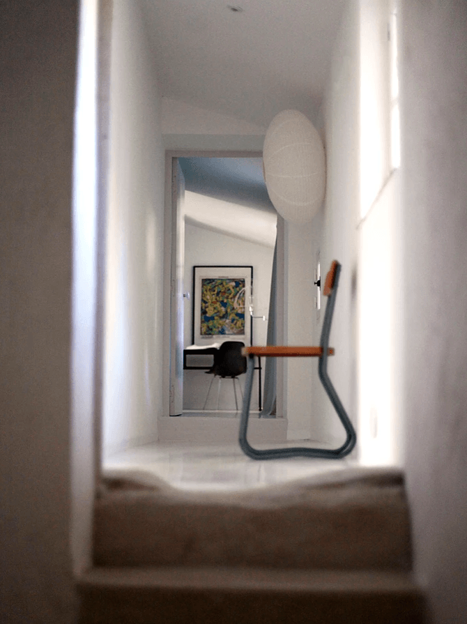 A school chair is among the eclectic furnishings and art at a former art director