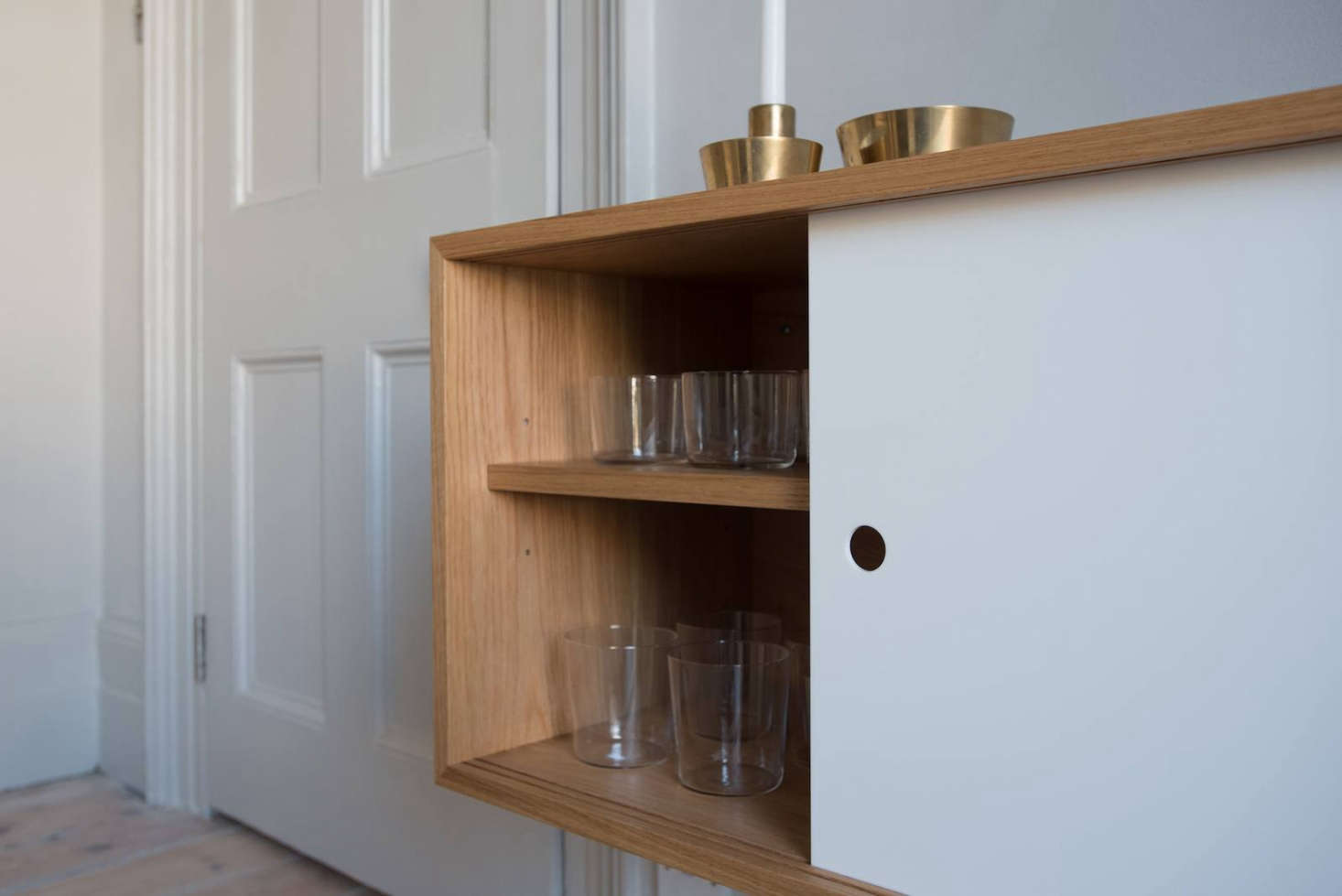 The sideboard is an extension of the kitchen and stores breakfast cereals plus everyday plates and glasses.