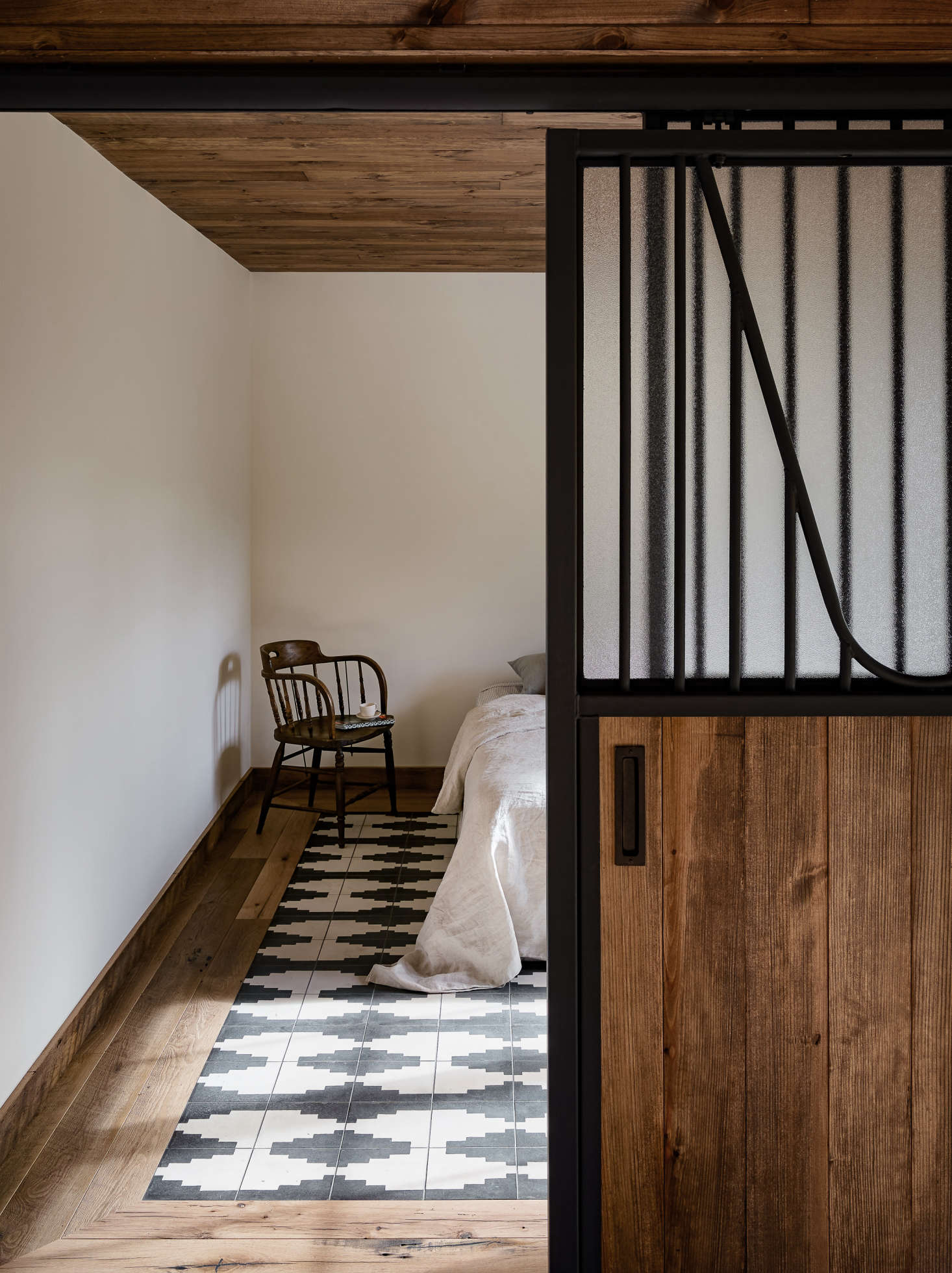 Though the guesthouse was rebuilt, the two bedrooms have the exact same dimensions and location as two preexisting horse-birthing stalls. Zames even used the same sliding doors, with refinished metal and obscured glass added for privacy.
