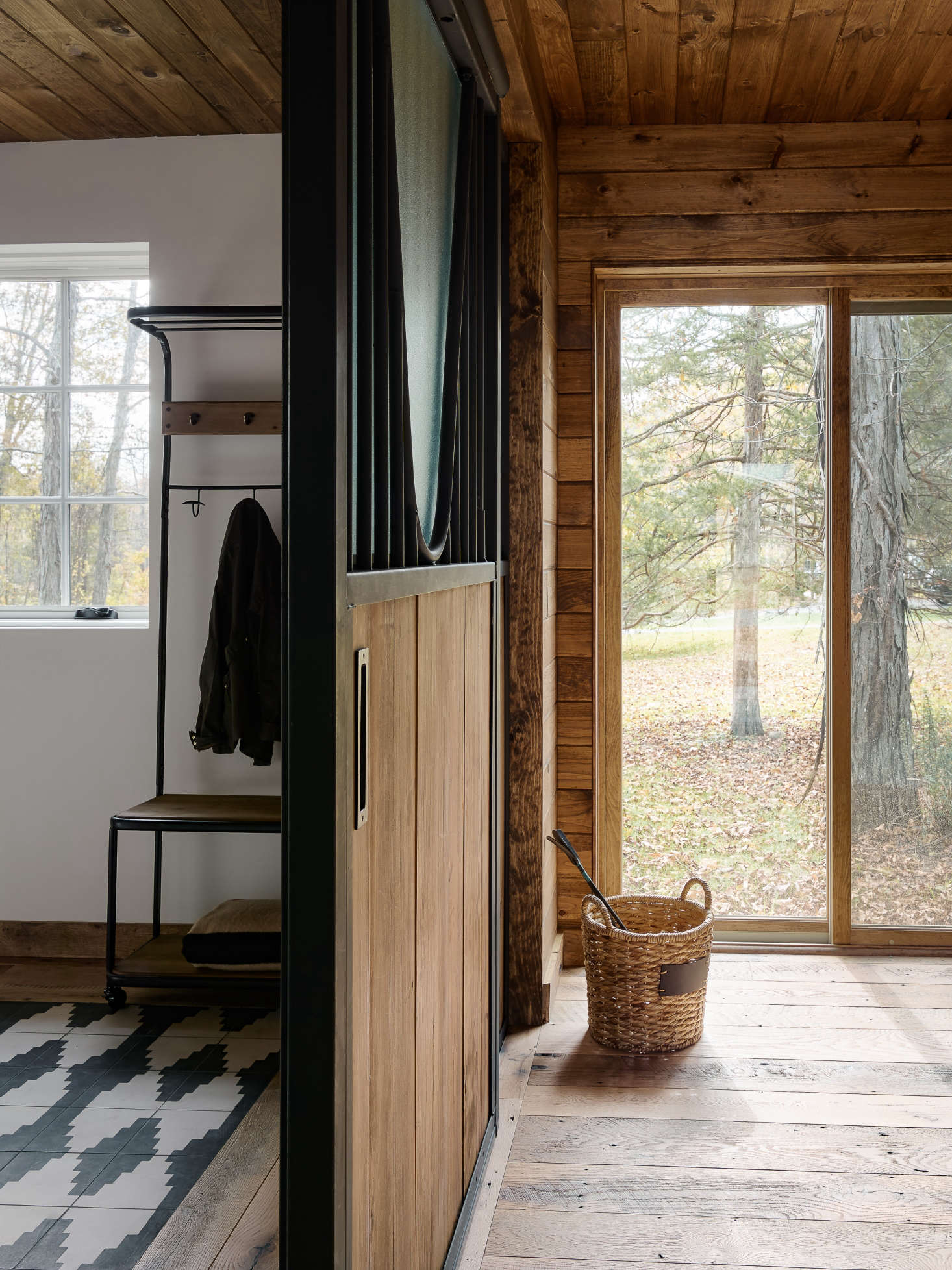 Zames employed a few tricks to define space within the large, open floor plan without using walls or paint. An example: “rugs” created using Commune’s black-and-white Concrete Tile in each bedroom.