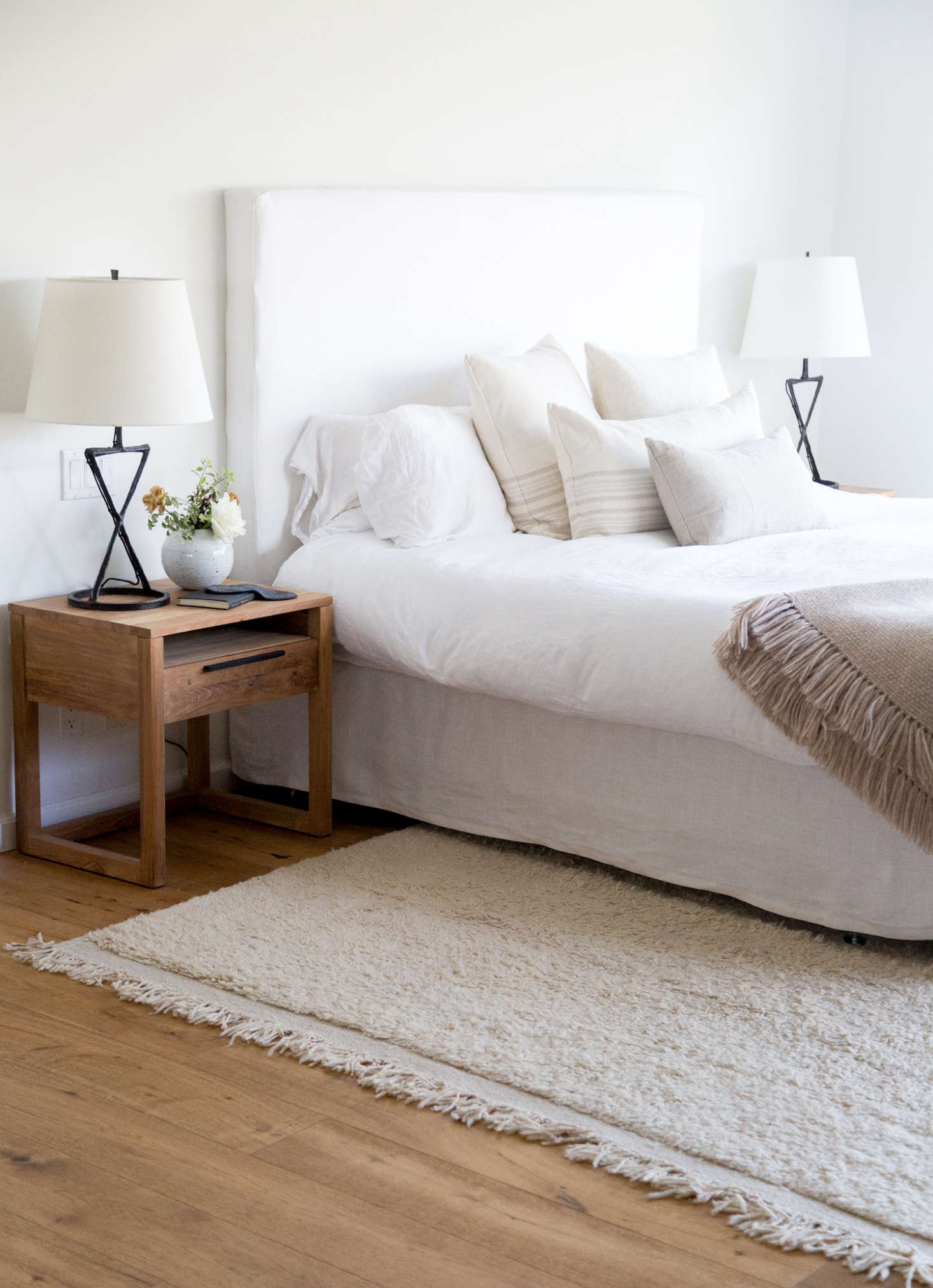 Hunter worked with interior designer Caroline Wolf on the master bedroom. The bedspread is from Matteo, and all the throw pillows are from Jenni Kayne Home: a Linen Seam Rectangle Pillow ($115) plus alpaca stripe pillows in Square and Rectangle ($195 each). On the bed is the Alpaca Basketweave Throw Blanket in oatmeal; $295. The Orb Vase on the nightstand is by Victoria Morris; $300.