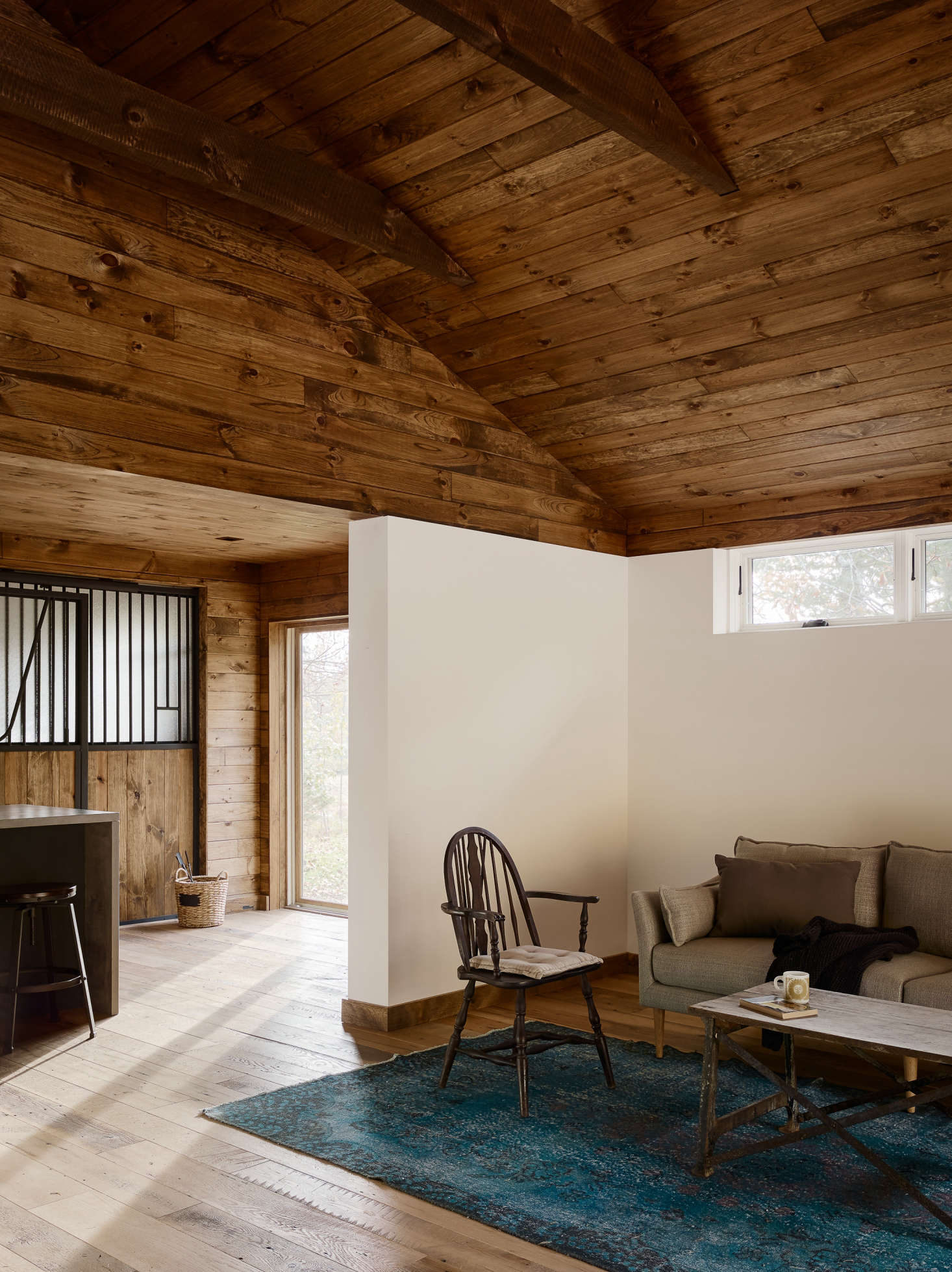 Next to the kitchenette is a sitting area with a mix of modern and traditional furnishings.