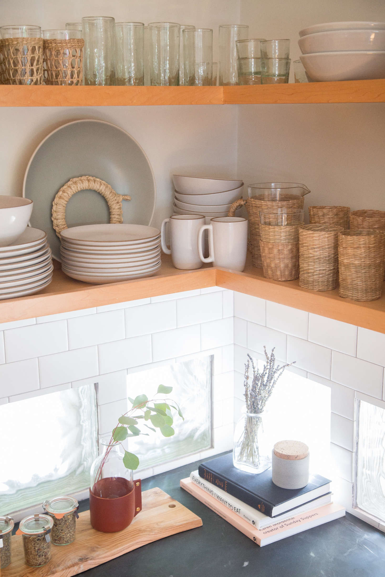 They kept some block glass in one corner of the kitchen, but replaced the Art Deco backsplash with white subway tile and gray grout “to keep it classic and light.”