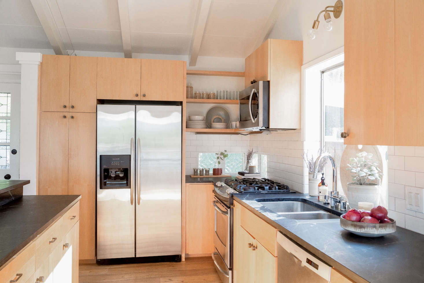 The couple opted for soapstone countertops, inspired by Remodelista’s own Primer on the subject (“we love the gray color and the natural look,” says Hunter). The cabinets were preexisting, and only needed new knobs and pulls.