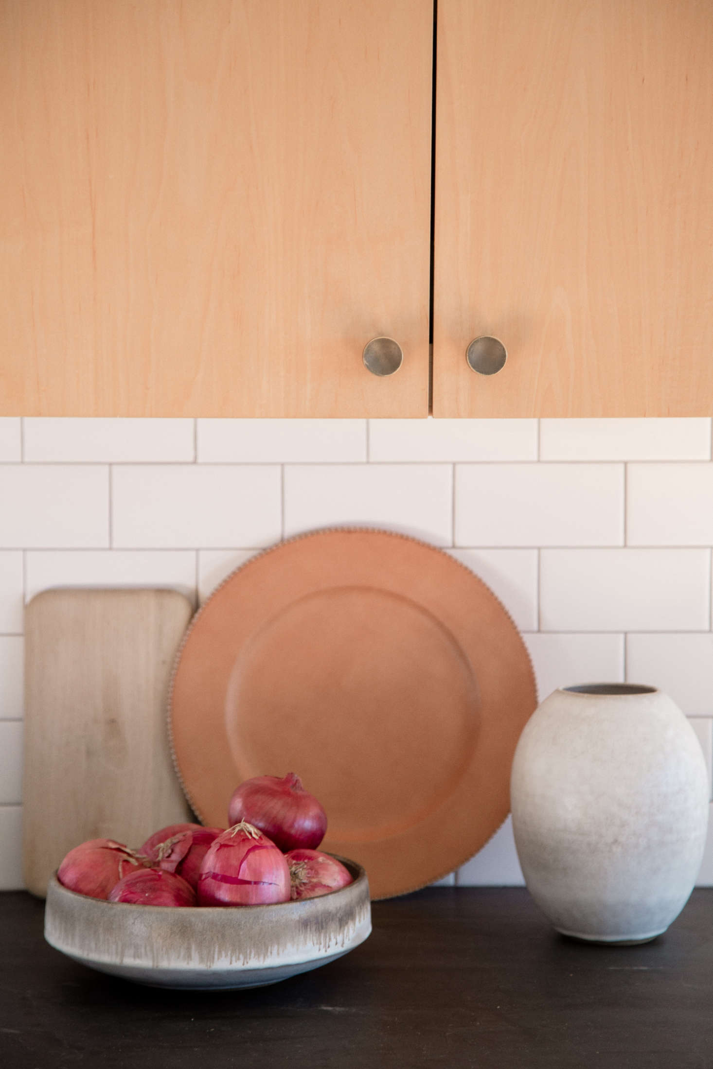 The brass kitchen cabinet knobs are from Schoolhouse Electric. The Oval Vase is by Victoria Morris ($350; currently sold out online).