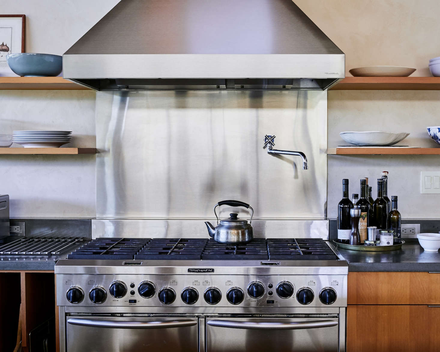 The backsplash of the oversize gas range is stainless steel, as are all the appliances (the material was chosen for its durability, said architect Anding). A Sori Yanagi Tea Kettle is perched on the stove (it’s one of the “Remodelista 100” all-time most useful and beautiful objects, as featured in our book).