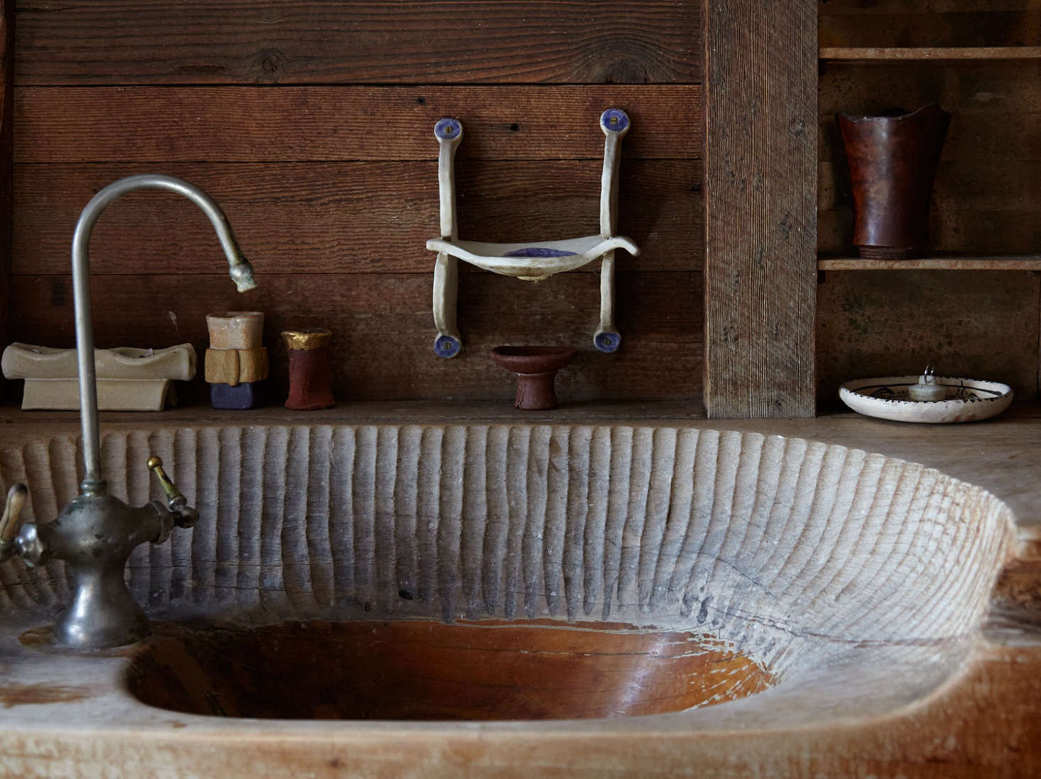 Blunk’s hand-hewn bathroom sink, with marks from his chisel.