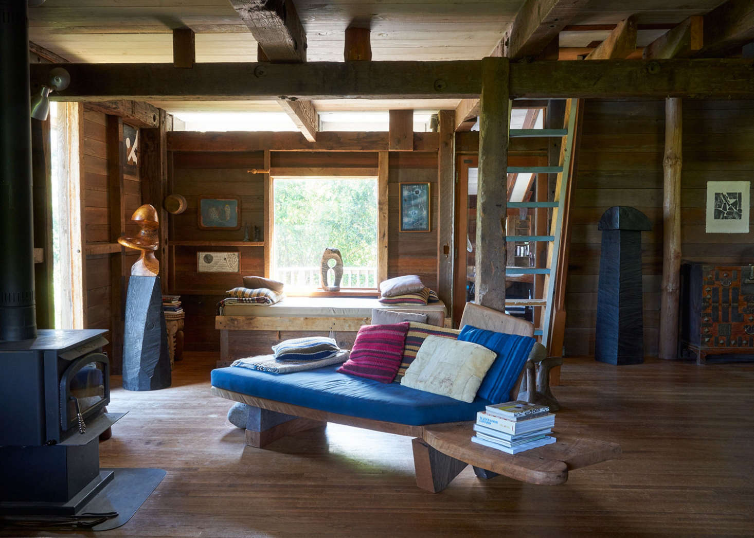 The open-plan living space, with a carved, benchlike couch.