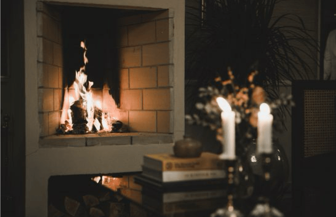 “We spent hours in the ‘living room’ by the fire,” Francesca says; the small fireplace is tiled, with wood stacked beneath.