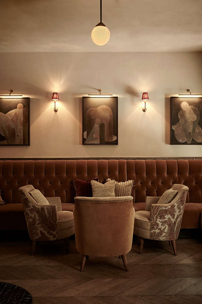 A sumptuous area for lounging, in hushed warm velvets that evoke a theater curtain.