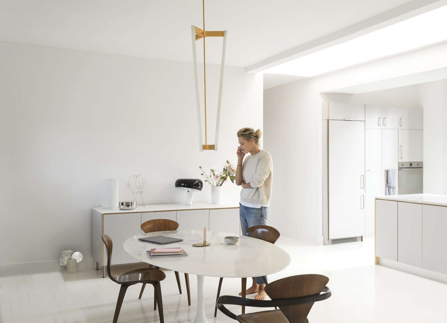 A long entry hall (with her children’s rooms and a bathroom off it) leads to a large, open living and dining space. Camilla gave the loft the Scandi treatment by whitewashing the walls (“in a universal white, matte, of course”) and floor (“a high-gloss epoxy, like a nautical paint, that can take the place of rugs”).