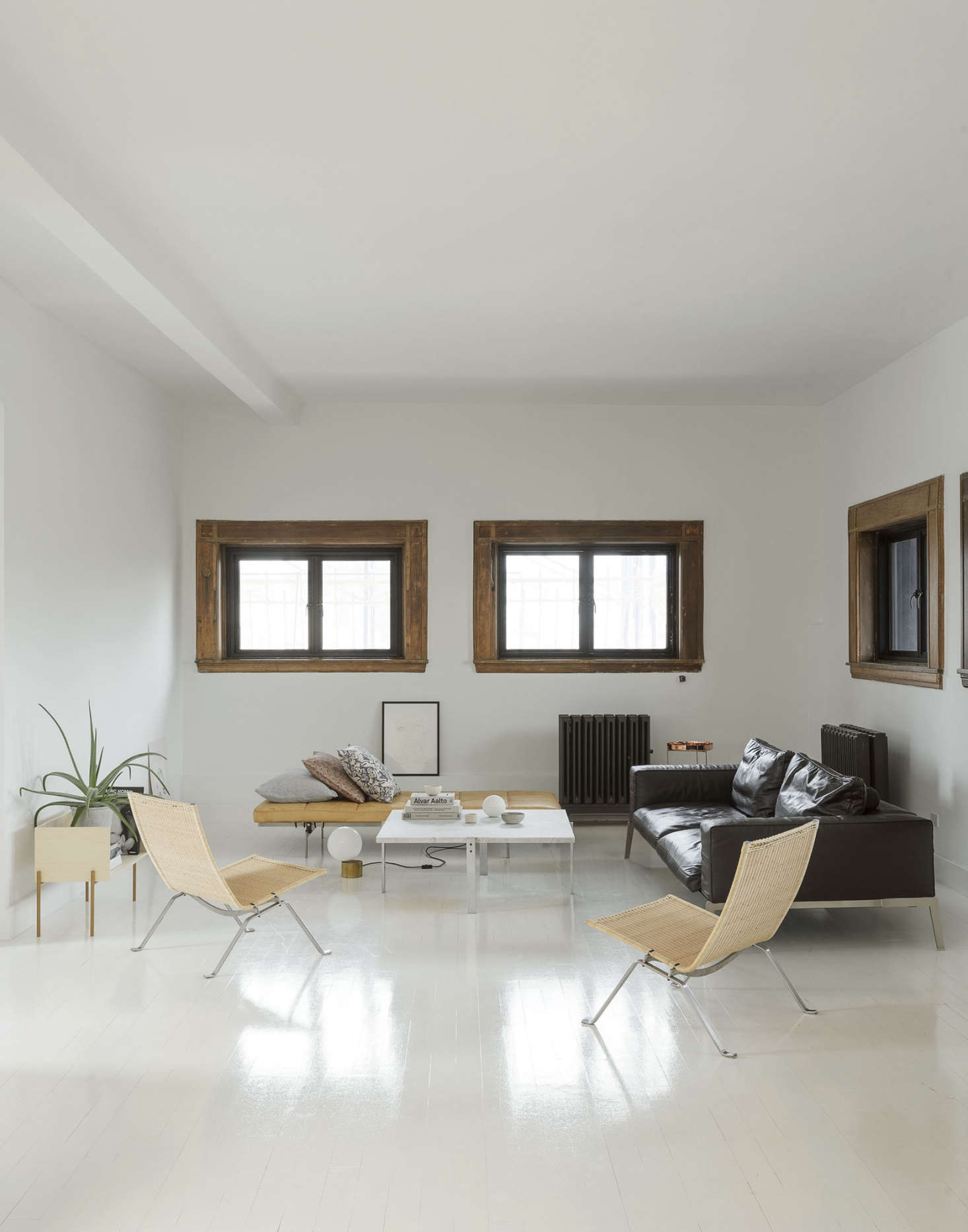 The living area is Camilla’s ode to Danish designer Poul Kjærholm: “His work is so minimal and timeless. I bought my first piece when I was eighteen with my first modeling money.” That was one of the pair of PK22 chairs shown here. When the wicker got worn out, she contacted Kjærholm’s son, and, at his suggestion, carried the frames back to Copenhagen, where he had his father’s weaver remake them.