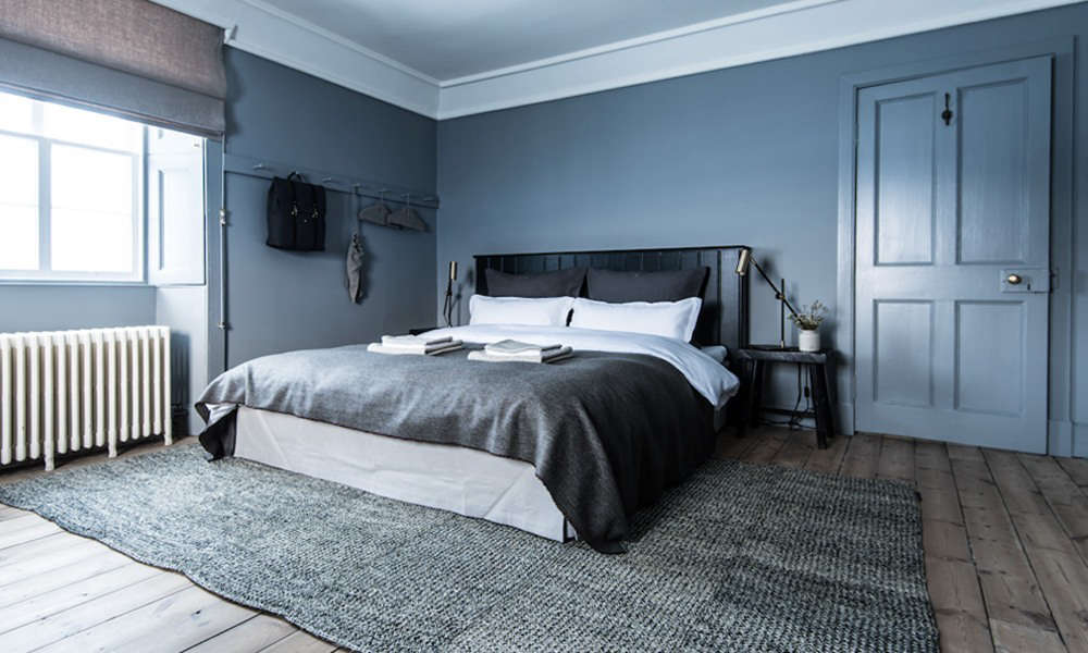 The Birch room is designed in layers of cool color. Photograph by Martin Kaufmann from In Scotland, A Luxe Nature Retreat from a Danish Billionaire.