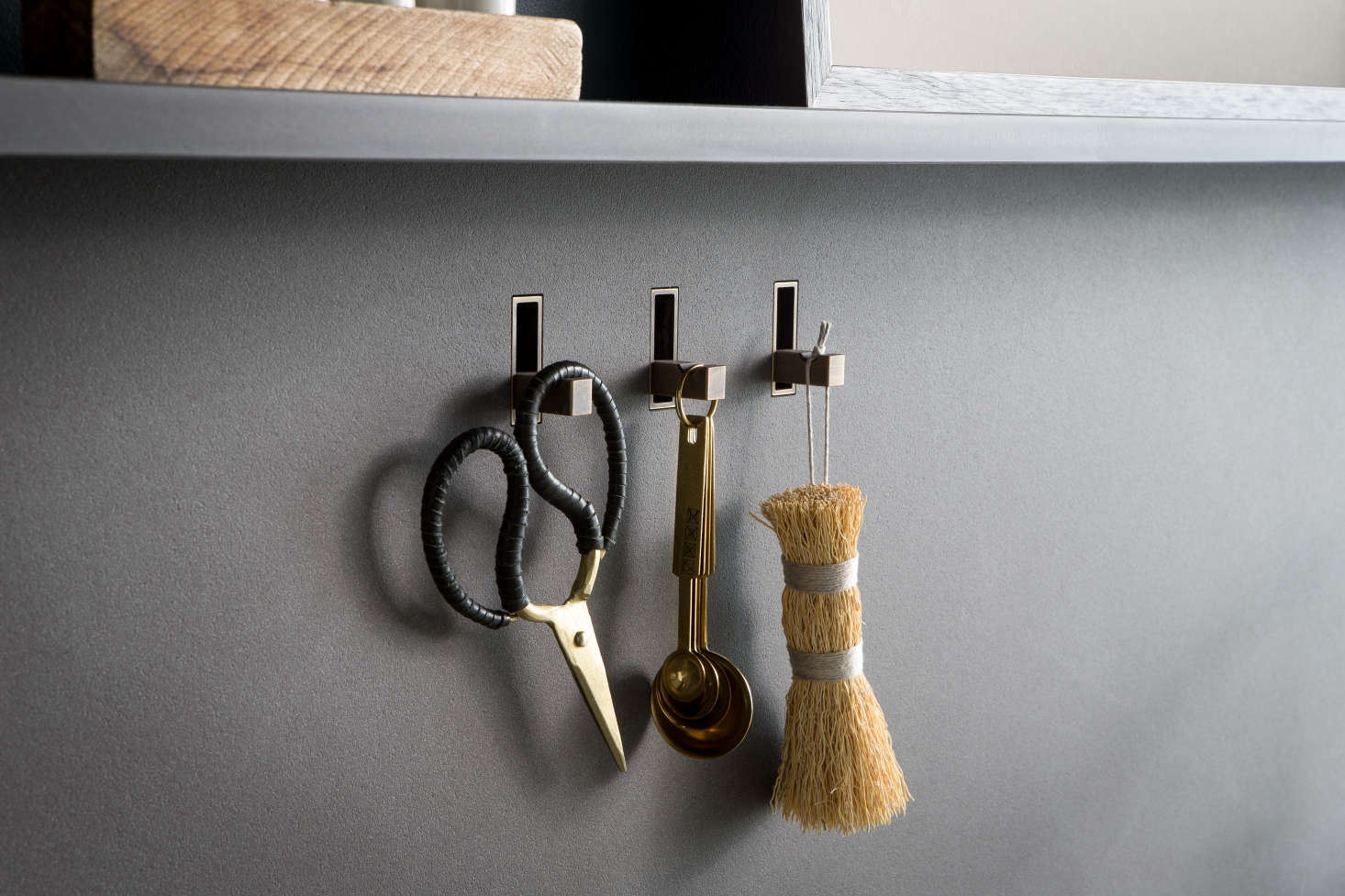 The hooks are integrated into the backsplash and can be finished to match any surface, so that when not in use, they disappear. For sink accessories, browse our Brushes & Sponges finds.