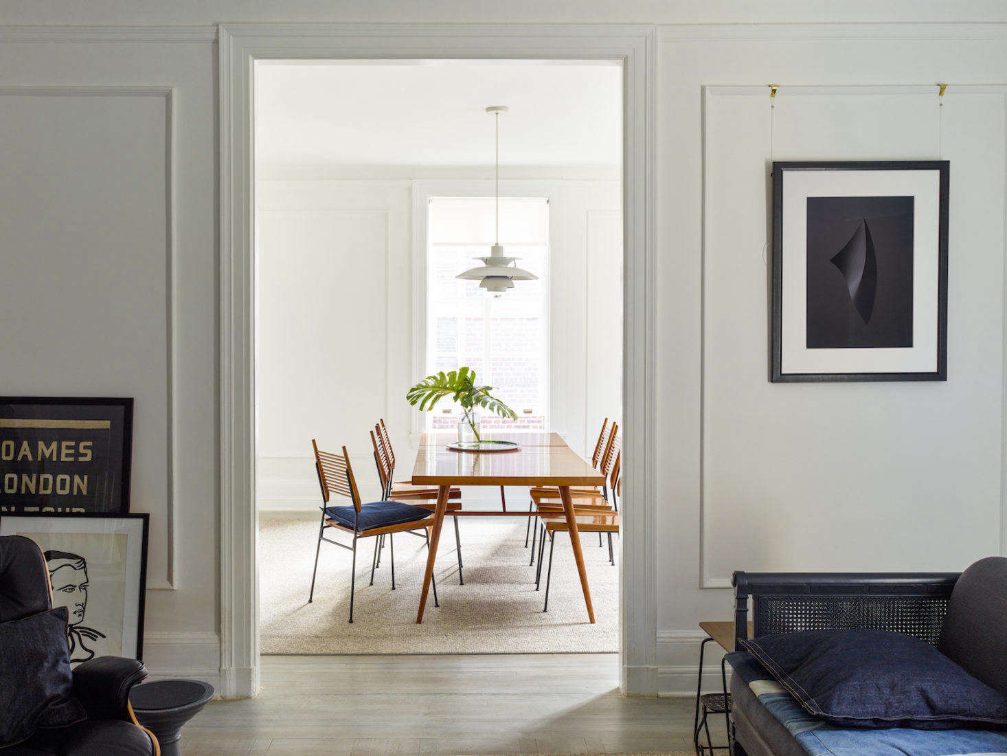 “To be honest, I’d prefer nothing on any of the walls!” says Axe. “That said, I like to think of hanging pictures as composing a photograph. My main goal for this apartment was how you view pictures from other rooms, as all the rooms are linked.” Here, a framed photograph by his friend Richard Foster hangs next to the doorway that connects the living room to the dining room.
