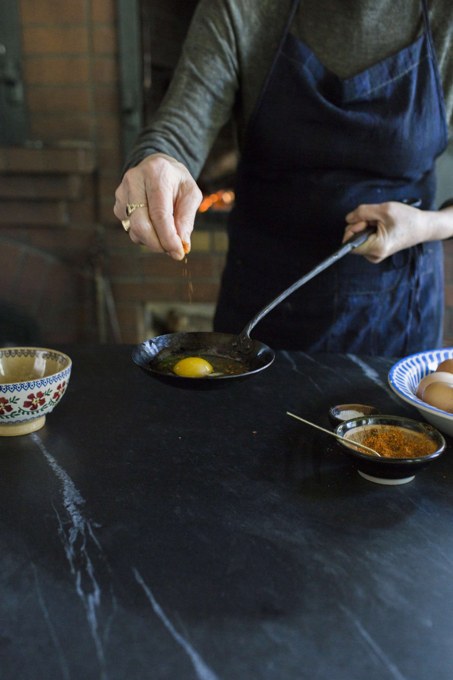 The original hearth-cooked egg recipe calls for salt, pepper, and a bit of olive oil. Alice adds paprika to her version.