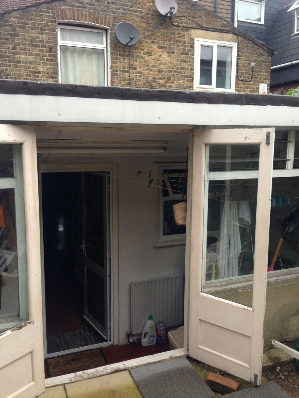 In a prior renovation, a glassed-in narrow porch had been tacked onto the back of the house.