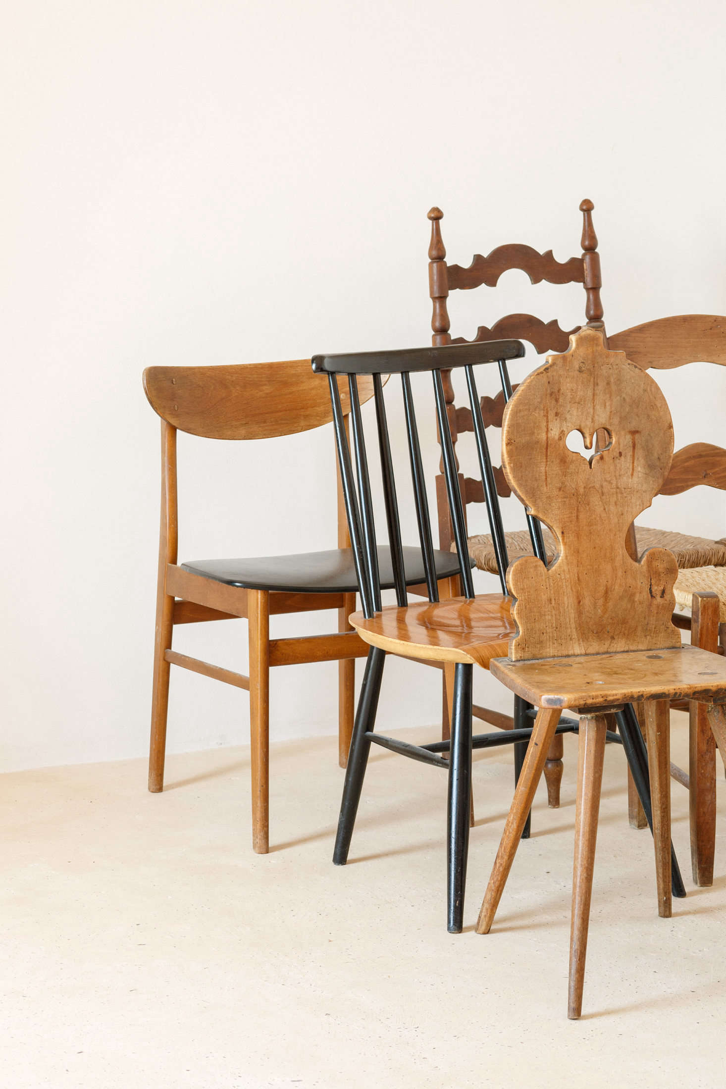 The chairs throughout the house are a mix of styles: “some existing Mallorcan-style chairs that were in the house (luckily the previous owners kept all existing furniture), some Scandinavian chairs bought in Basel and in flea markets in Paris and Belfort, an Eames Vitra Wire Chair from Basel, and a traditional Swiss wooden chair, bought in a brocki (a secondhand shop, typical in Switzerland),” the architects say.