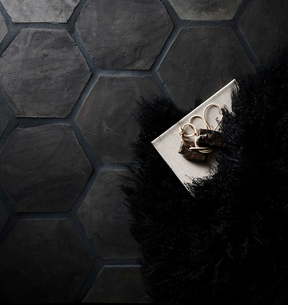 Eight-inch Hexagon tile installed as flooring, with dark charcoal grout.