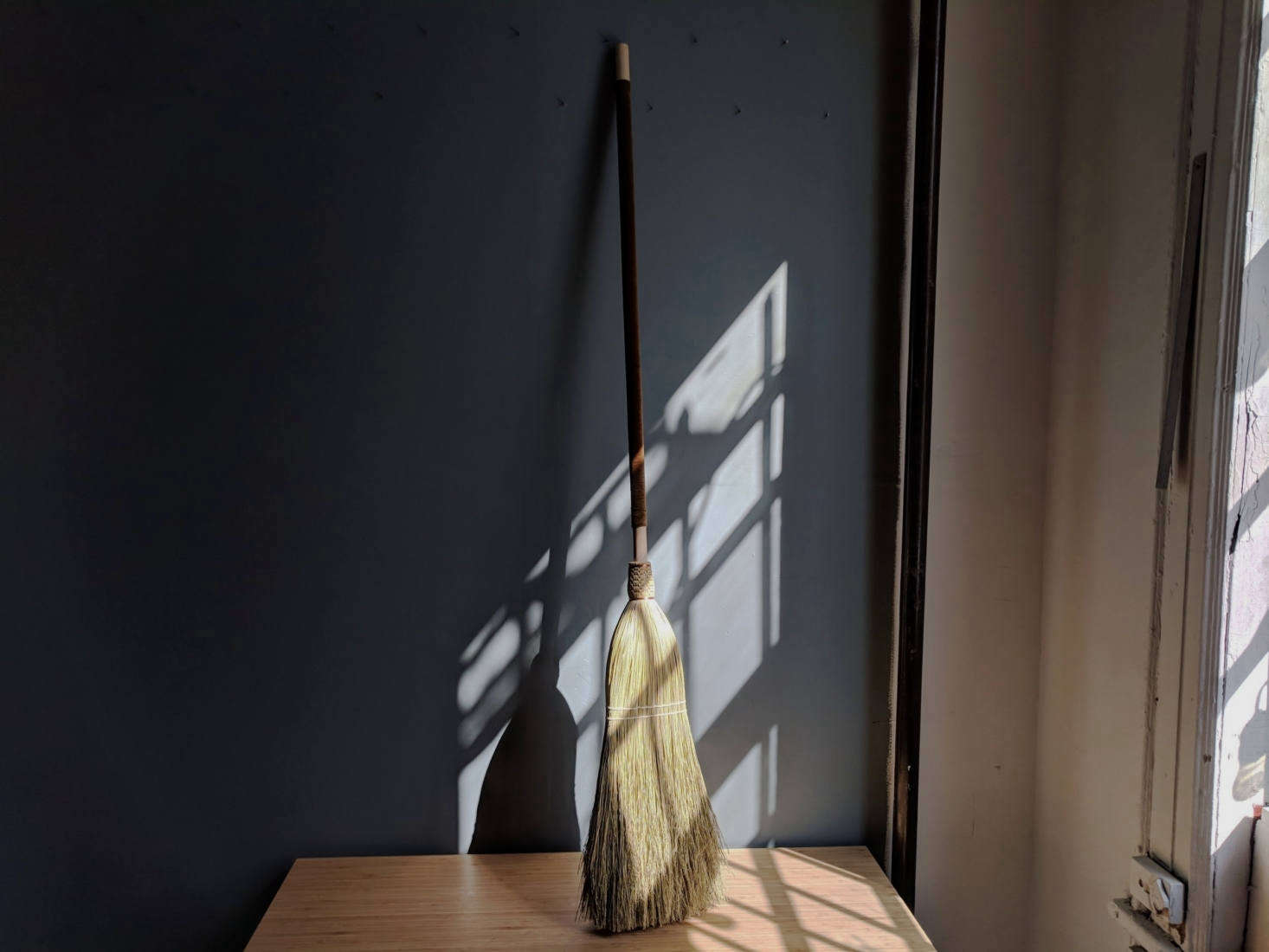 A custom broom has an olive green velvet cover.