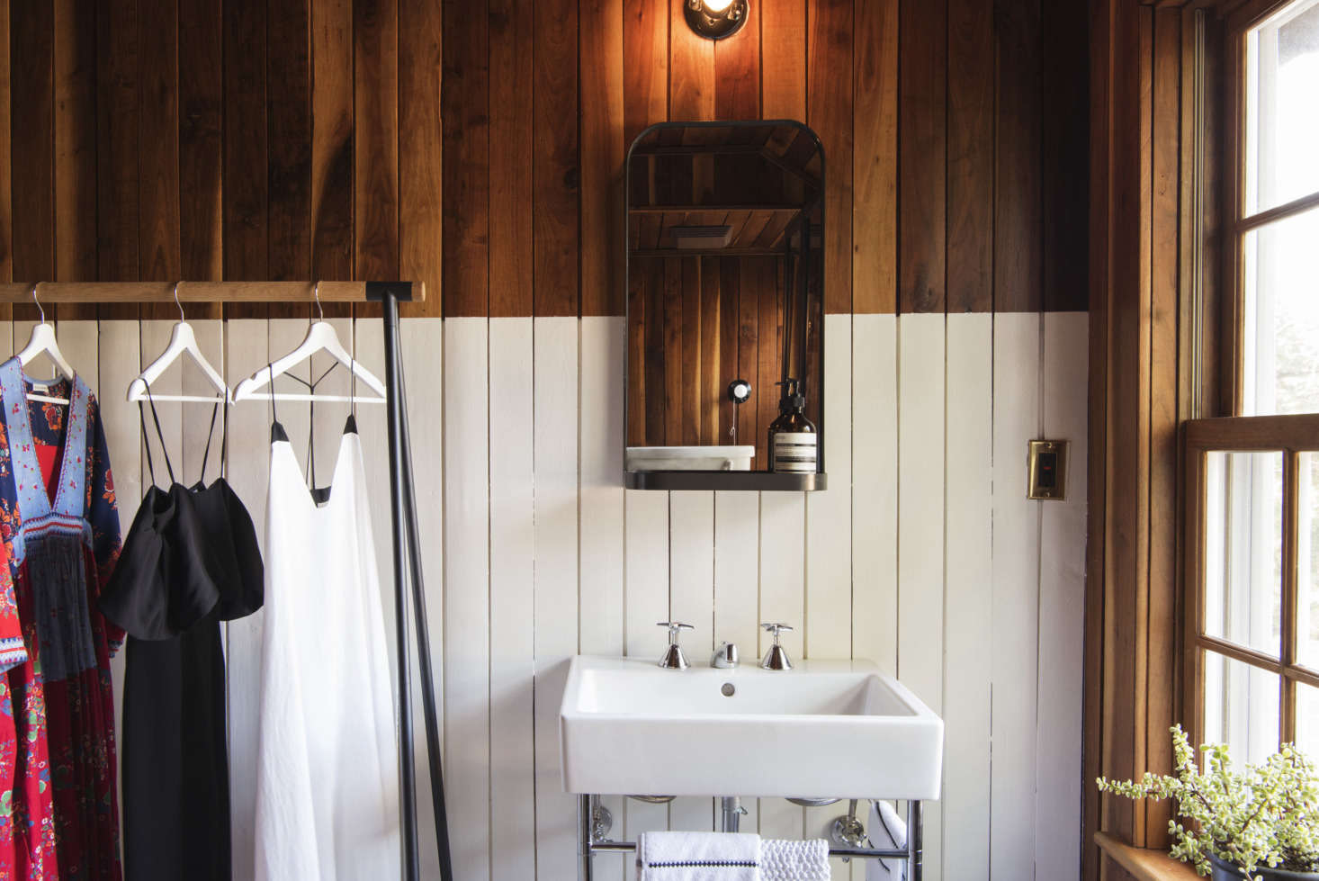 Elizabeth painted the lower half of the master bathroom paneling white.