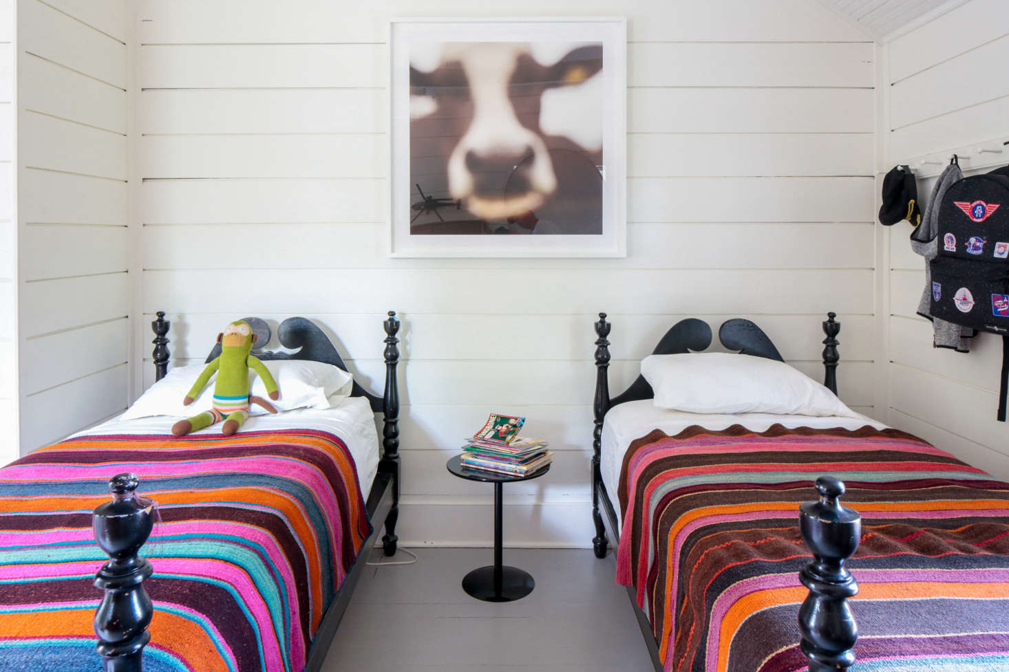 The twin beds in her son’s room were left by the previous owners. The Bolivian striped blankets are from L’Aviva Home.