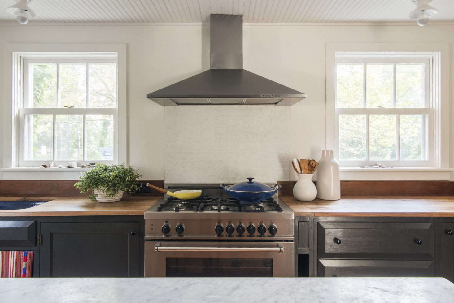 The countertops are walnut and white marble.