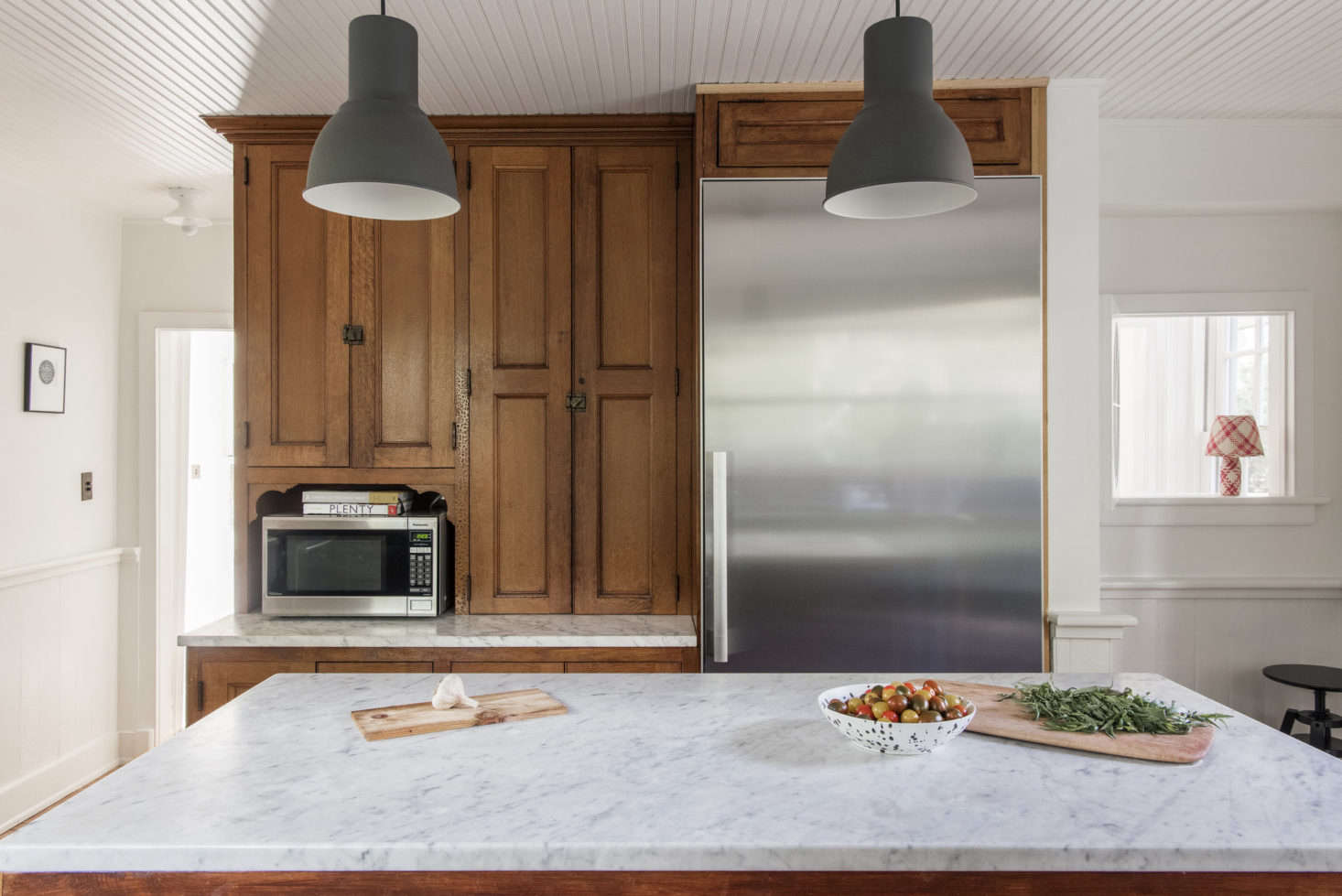 The kitchen pendant lights are Hektar from Ikea.