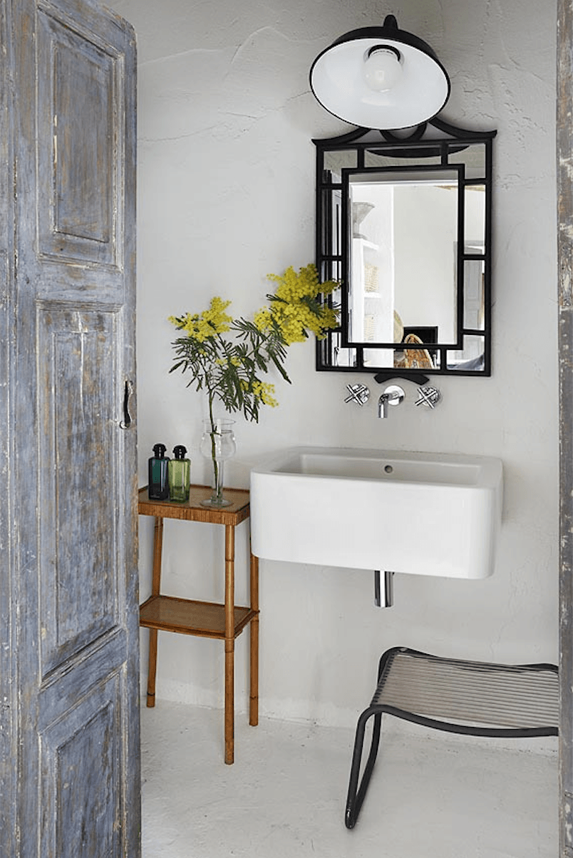 The bathroom is lit by a black wall light, similar to the one over the kitchen.