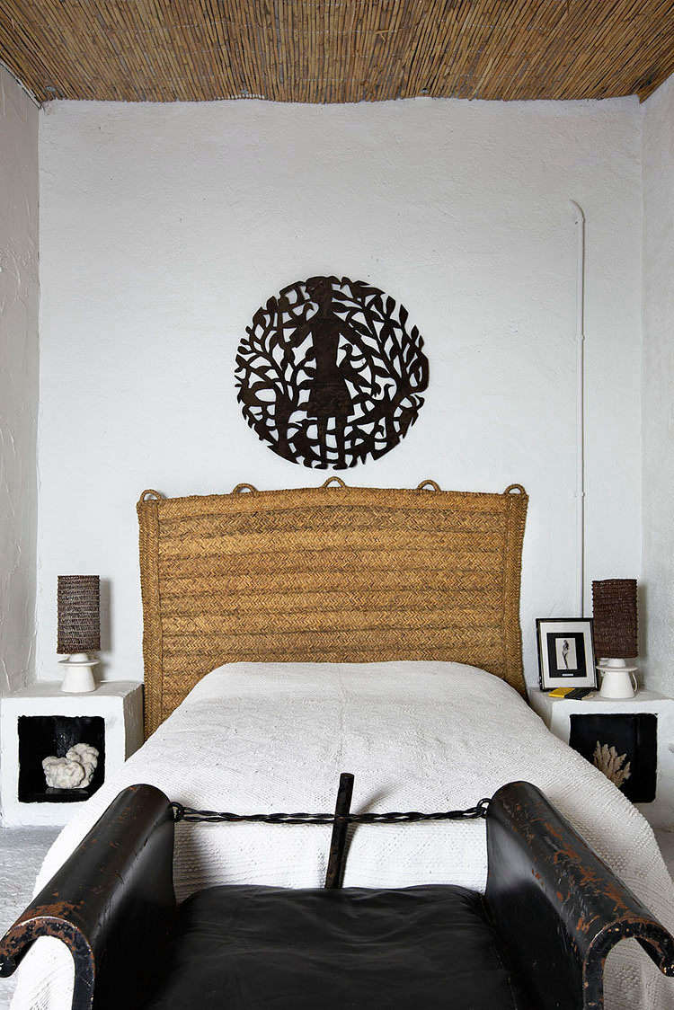 In another bedroom, sculptural built-in nightstands with black-painted niches flank the bed. The rattan headboard is Castella’s original design, inspired by straw rugs and handmade by craftsmen in Spain. (See our original post on it, and a few sources for getting a similar look at home, at Design Idea to Steal: A DIY Headboard from a Natural-Fiber Rug.)