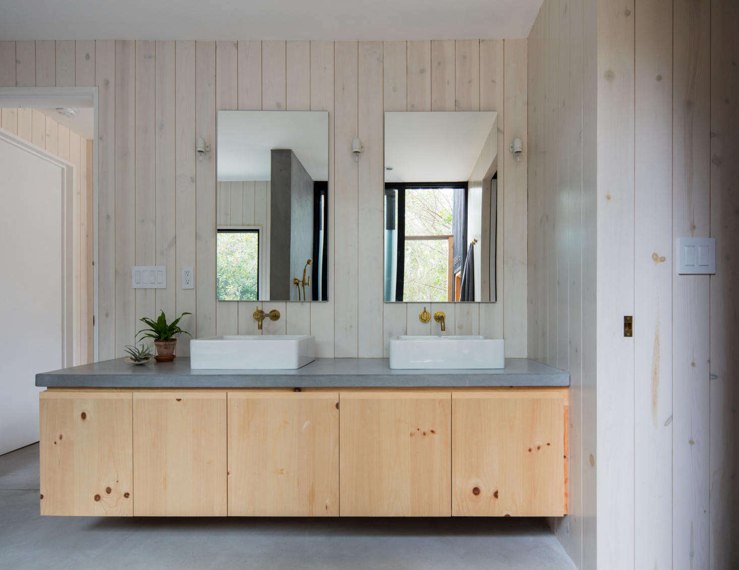 There is one full bath in the house, shared by the family, a decision made early on to maximize living space. The vanity has cabinets of heart pine wood in a clear stain. “The kitchen island and the bathroom vanity, as the only ‘autonomous’ pieces of built-in millwork in the house, are the only locations with a clear stain,” Ryan says.