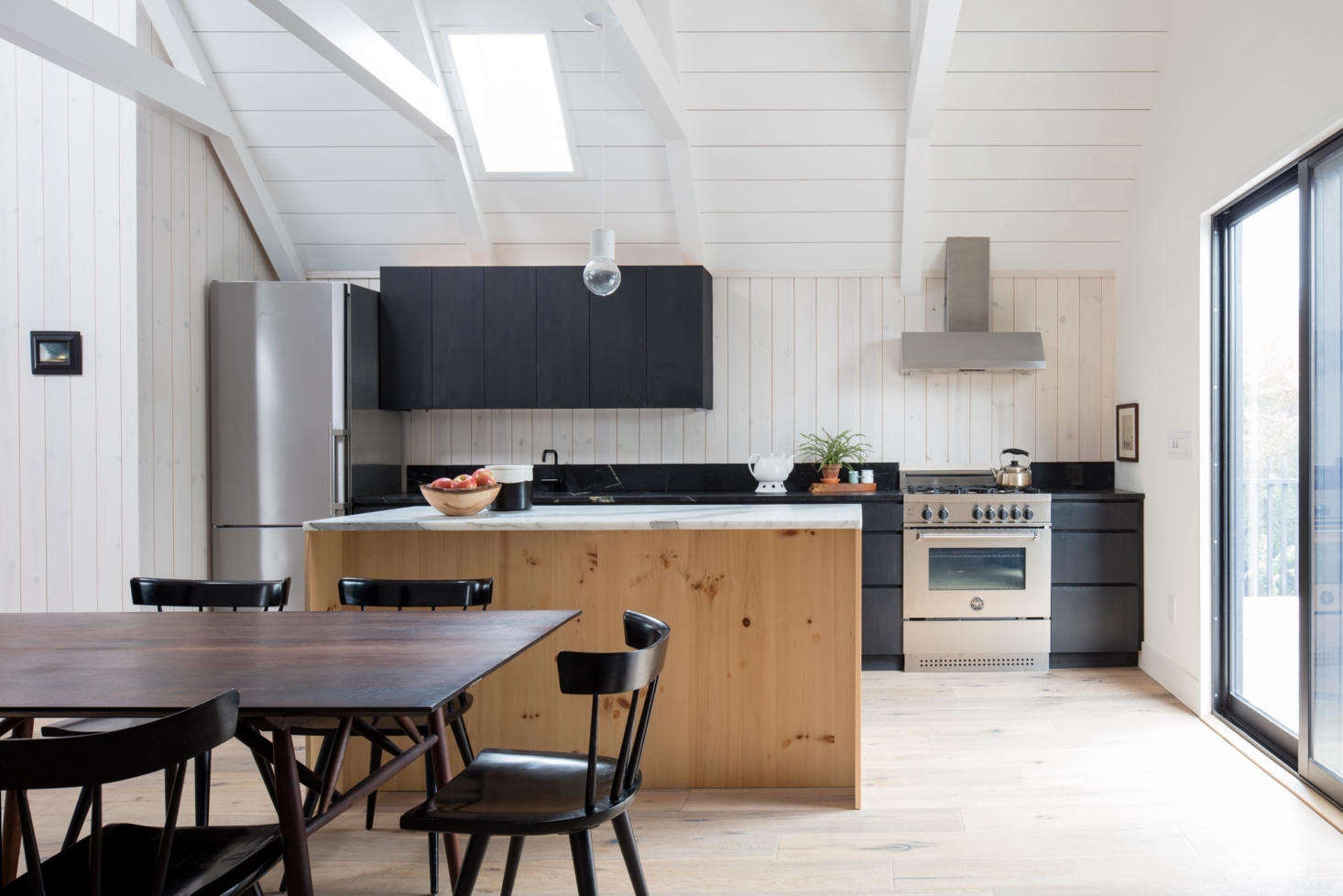 Though the kitchen is compact, it has a full suite of appliances, including a four-burner Bertazzoni range and a Bosch refrigerator (see 10 Easy Pieces: Best Skinny Refrigerators). The cabinets are pine wood, stained the same black color as the exterior cladding. “It’s the only black stain inside,” Ryan says, “and it gives a special distinction to the communal nature of the kitchen for the family.”