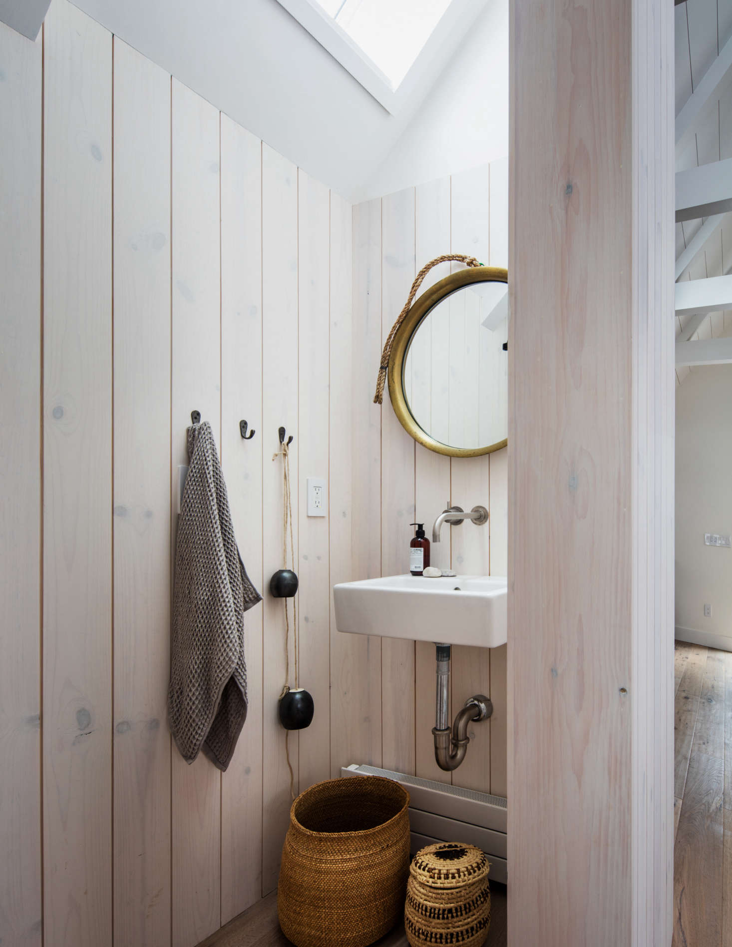 The upstairs powder room is whitewashed pine.