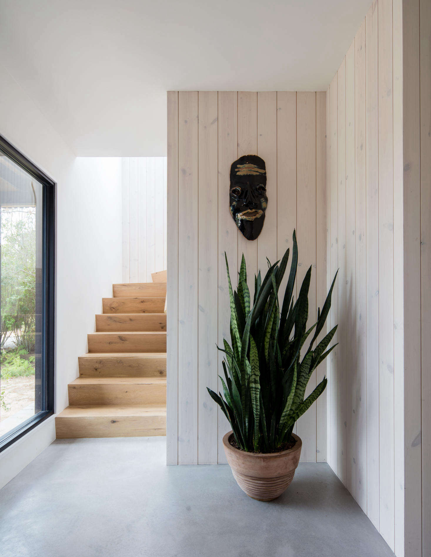 In the entryway a sansevieria plant sits beneath a mask collected on the couple’s travels. (Before they married, Gibson and McManus each traveled extensively—she through Asia and he through Europe and Central America.)