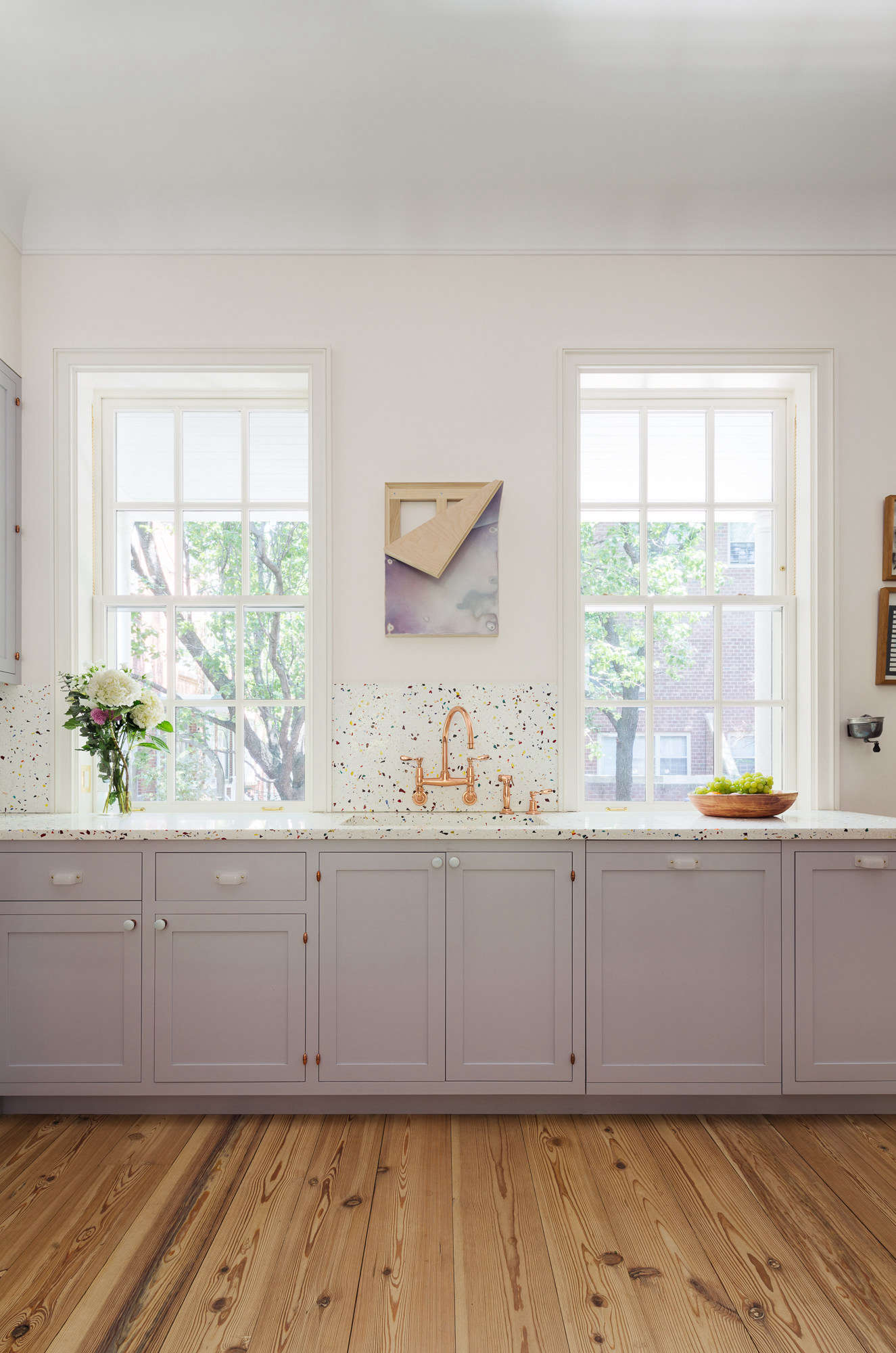 The kitchen has terrazzo counters and a copper sink. Photograph by Devon Banks, courtesy of Yun Architecture from Layers of History—and Color—in an Artist Couple’s Manhattan Townhouse.