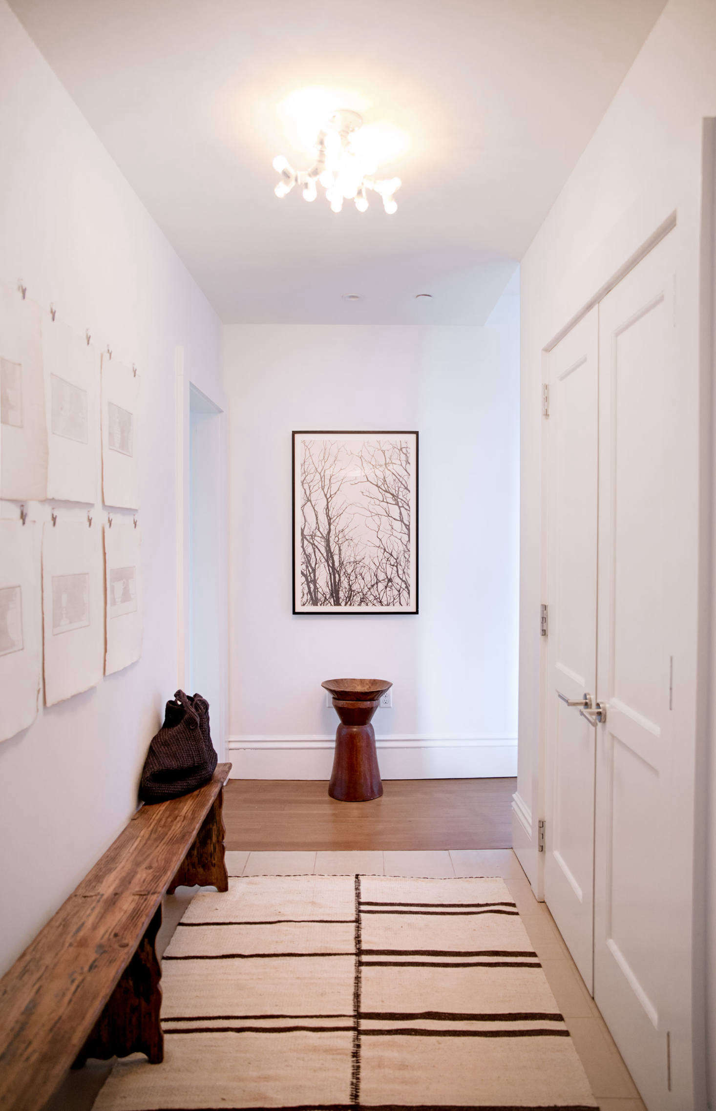 The entry hall is illuminated by a playful light that Jeffrey made from Home Depot parts.