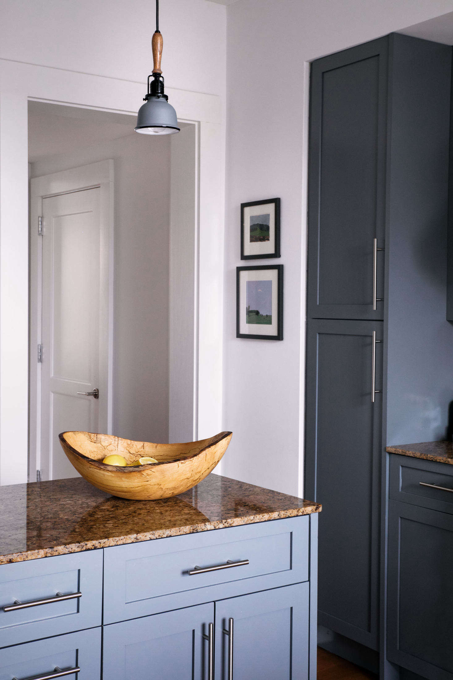 Complementary accents such as a wooden bowl and coordinated art unify the space in a way that minimizes the less attractive elements.
