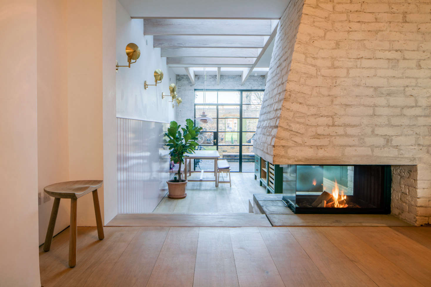 The centerpiece of the kitchen: a new, custom brick fireplace. “We also have an unhealthy obsession with wood-burning fireplaces,” Toke says.
