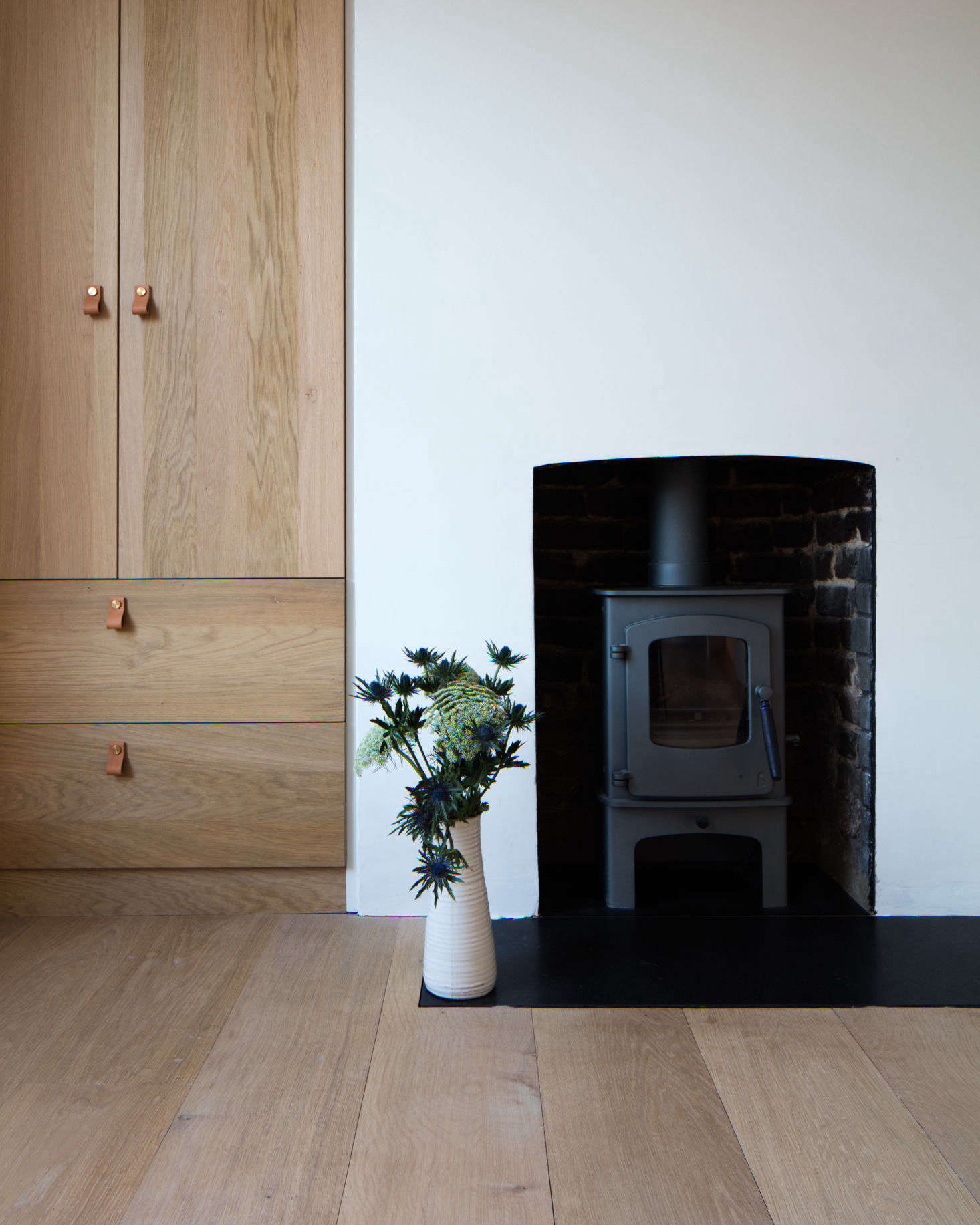 More evidence of the couple’s predilection for wood-burning stoves. The cabinets are also Dinesen, designed by Tuck and built by Lionhead Construction. The leather cabinet pulls are Superfront’s Loop design.